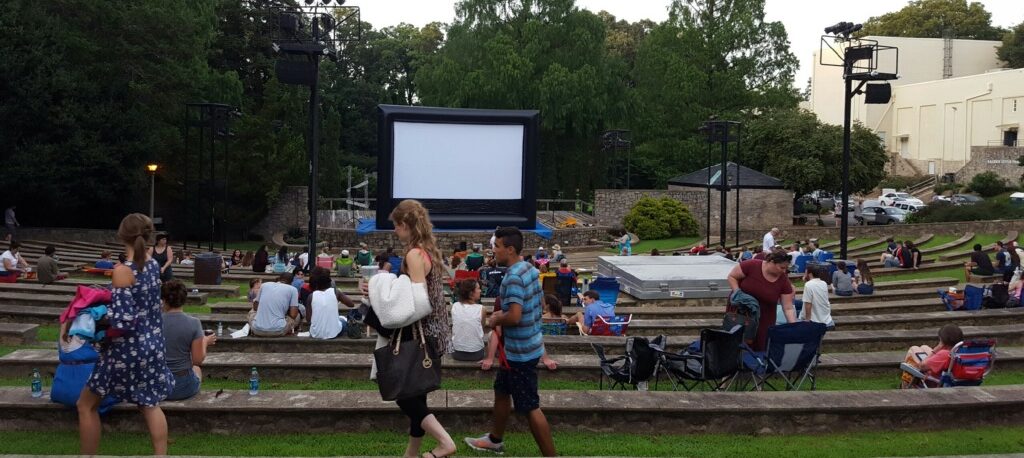 Amphitheatre with people setting up for a movie